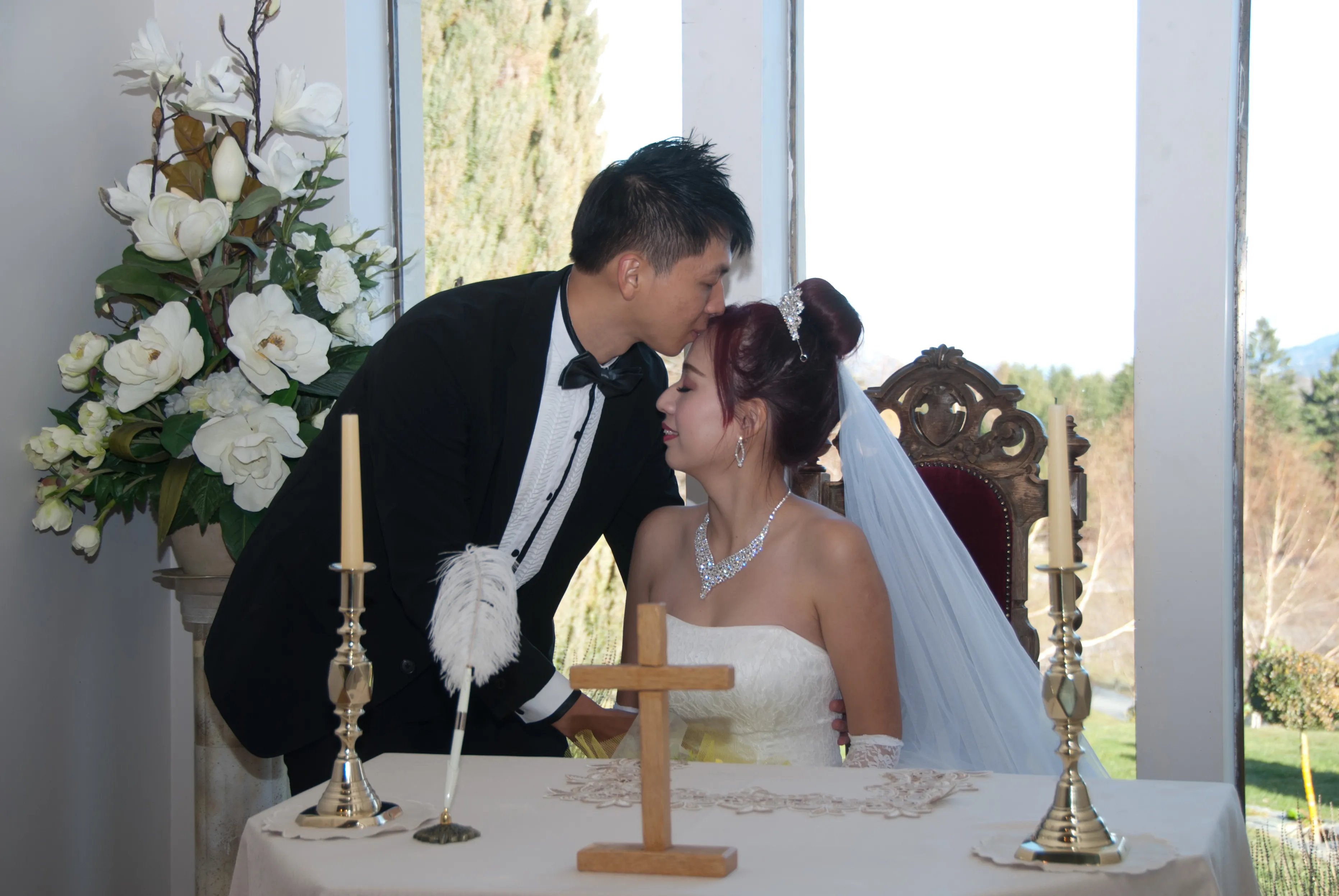 A newlywed couple at the signing table inside Chapel by the Lake, Stoneridge Estate