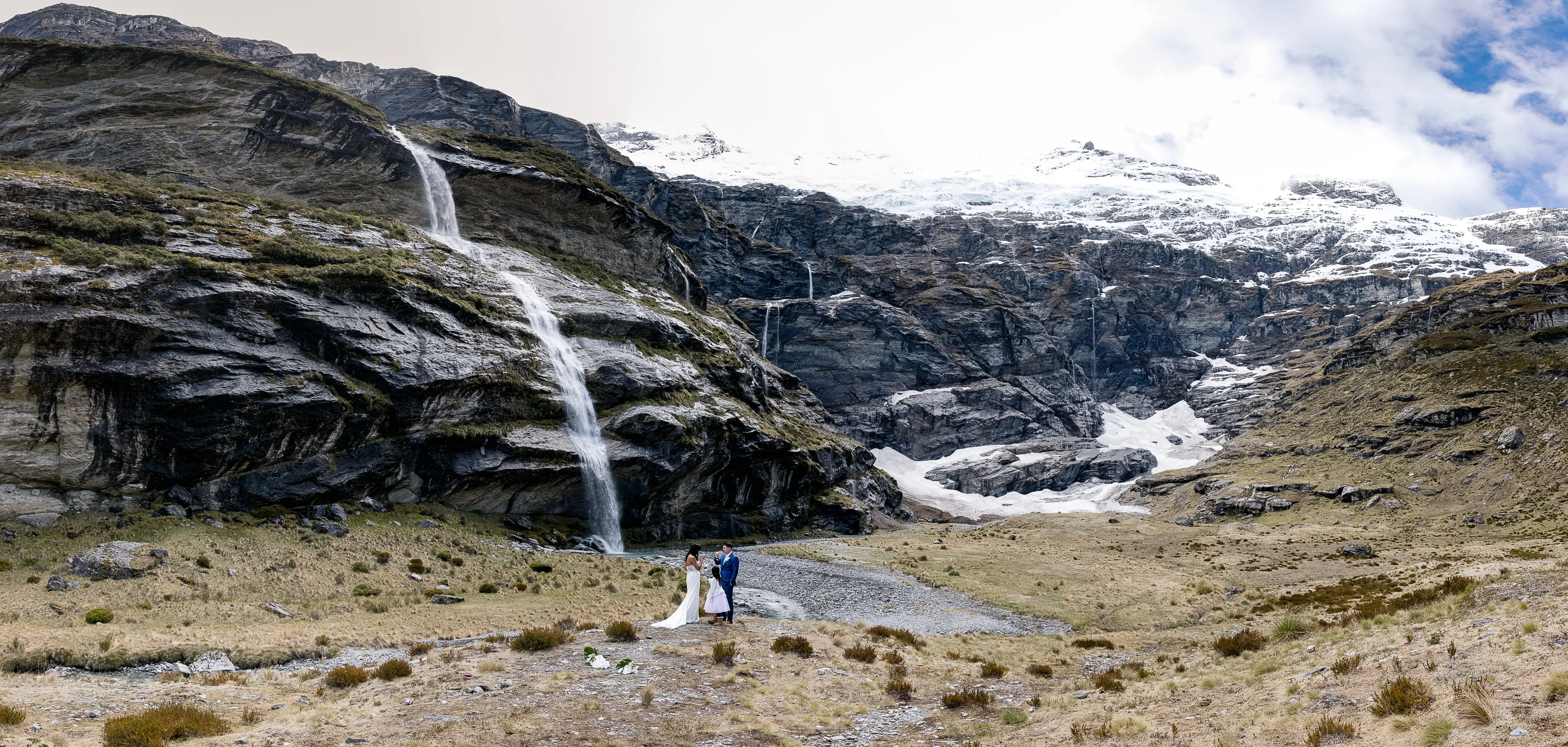 A wedding ceremony beside a waterfall on the floor of the Earnslaw Burn valley