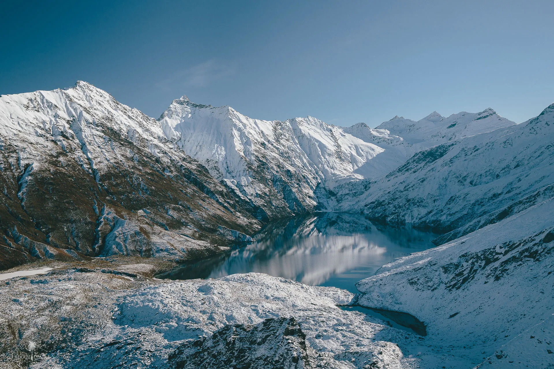 The remote alpine lake of Lochnagar ringed by the snow-capped Southern Alps
