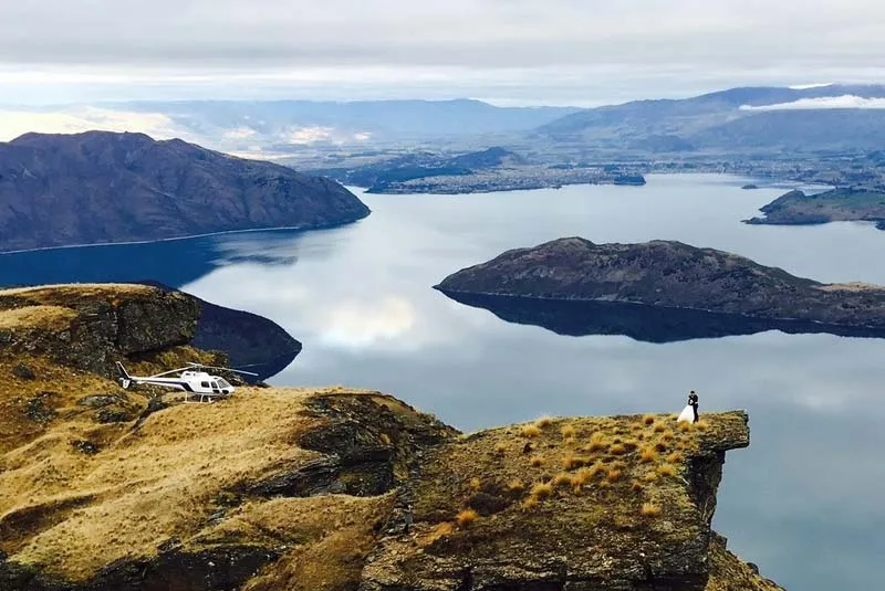 A helicopter landed on the private Lookout Hill clifftop high above Lake Wānaka