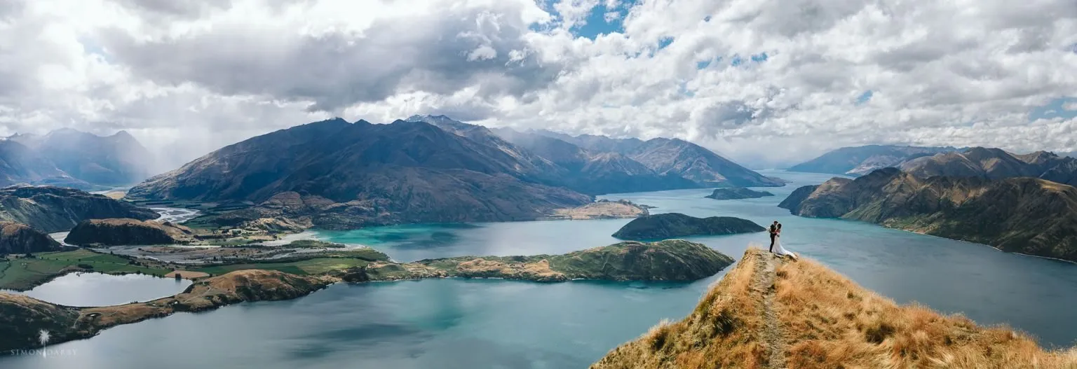 Couple standing on the ridge of Coromandel Peak above Lake Wānaka