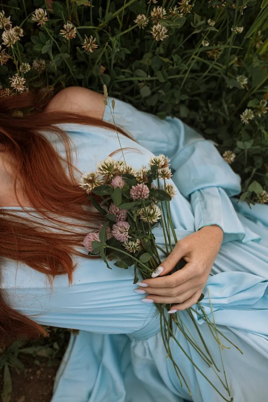 Lying in the clover Woman in a pale blue dress lying in clover holding a posy of flowers