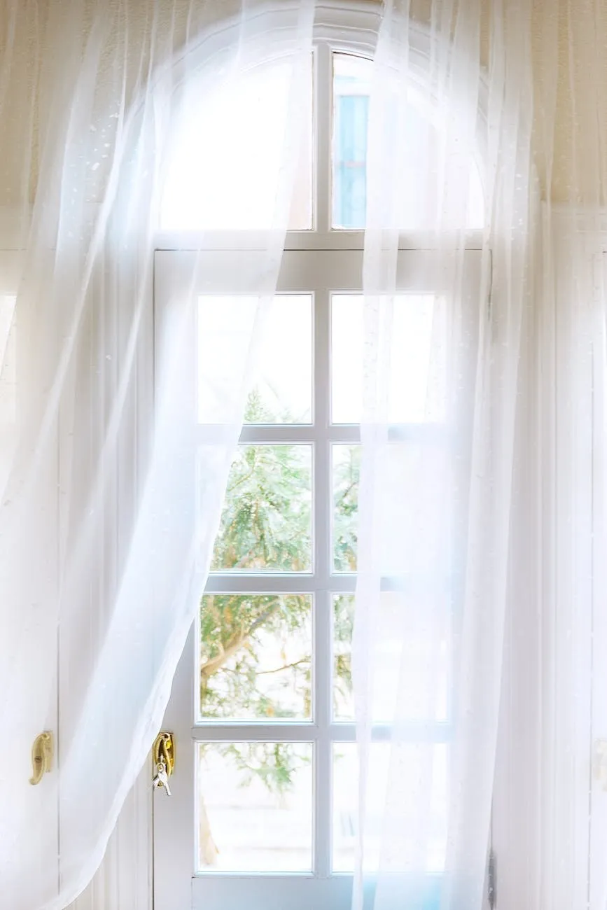 Soft natural light through a sheer curtain at an arched window