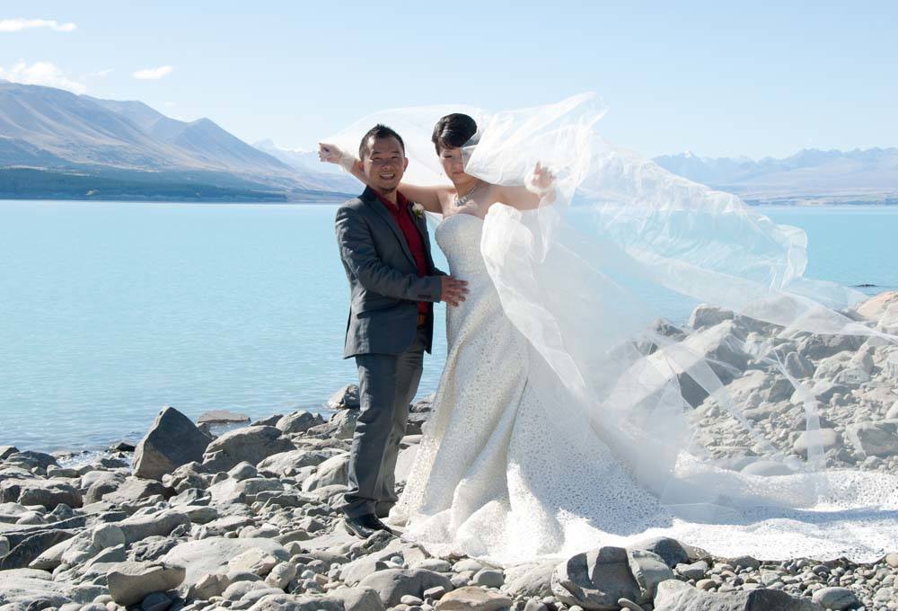 Couple on the shores of Lake Pukaki for their dream Lake Pukaki Wedding