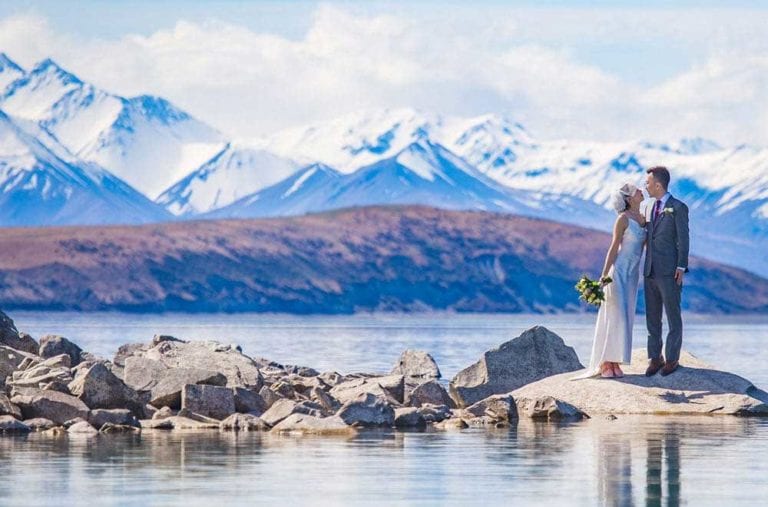 Lake Tekapo elopement wedding overlooking turquoise water and snow-capped mountains