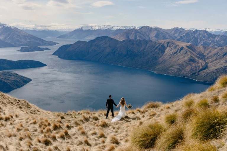Couple standing on a mountain ridge during their Lake Wānaka heli elopement – New Zealand Dream Weddings